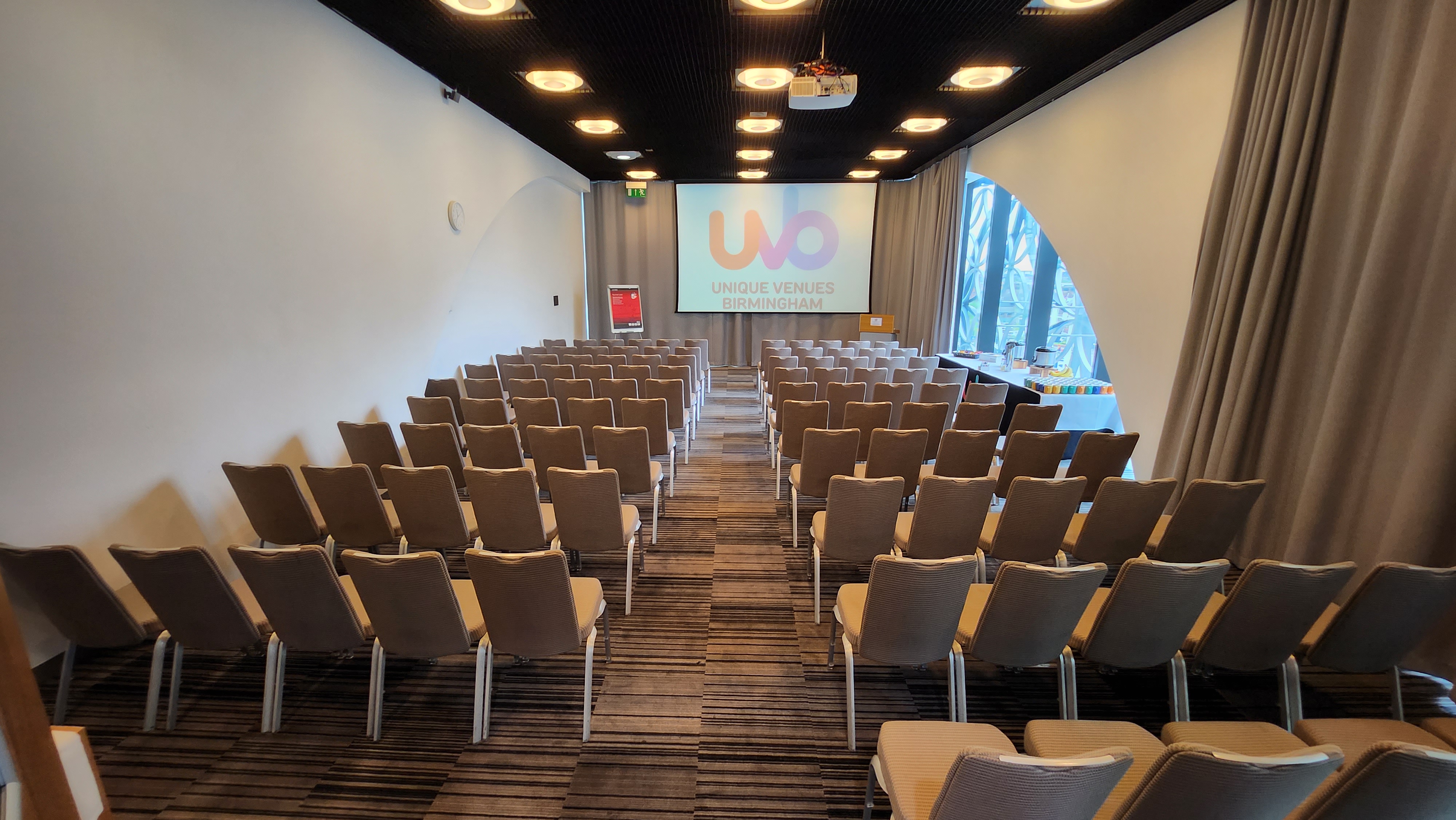 Modern meeting space with chairs and projector for conferences in Birmingham.