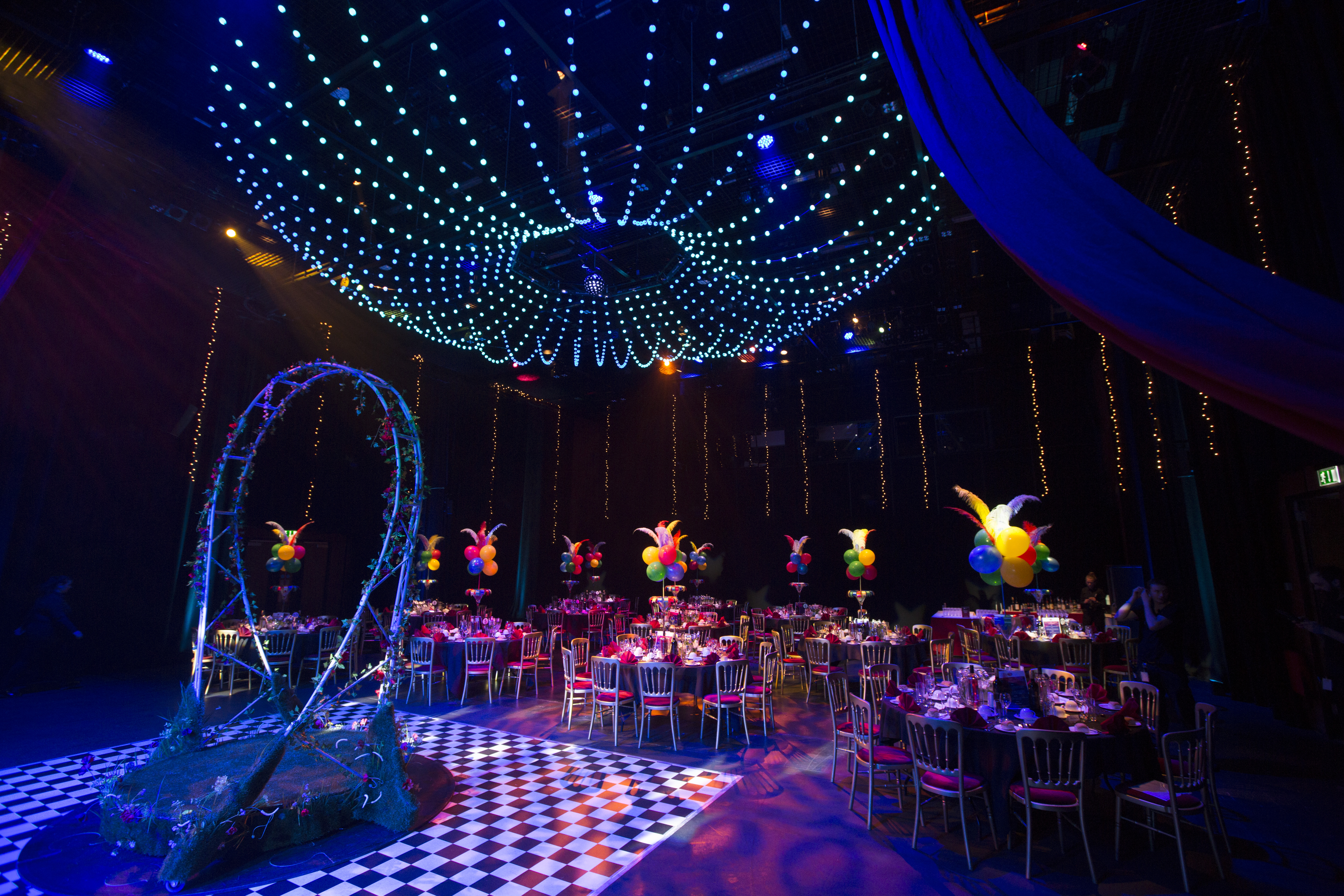 Elegant gala event space with round tables and vibrant decor at Birmingham REP.