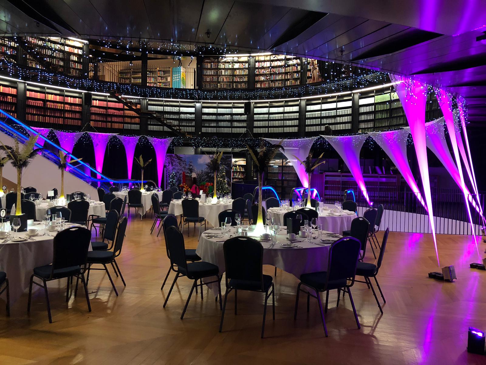 Elegant event space in Book Rotunda, Birmingham with stylish tables and vibrant lighting.