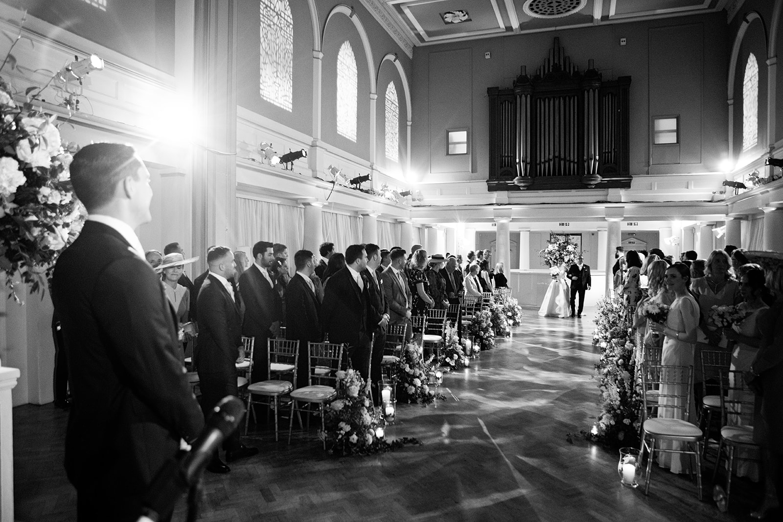 Elegant wedding ceremony in Soane Hall, featuring floral decor and romantic lighting.