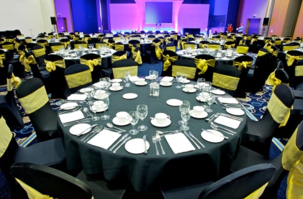 Gala banquet at Edgbaston Stadium with black and gold decor for formal corporate events.
