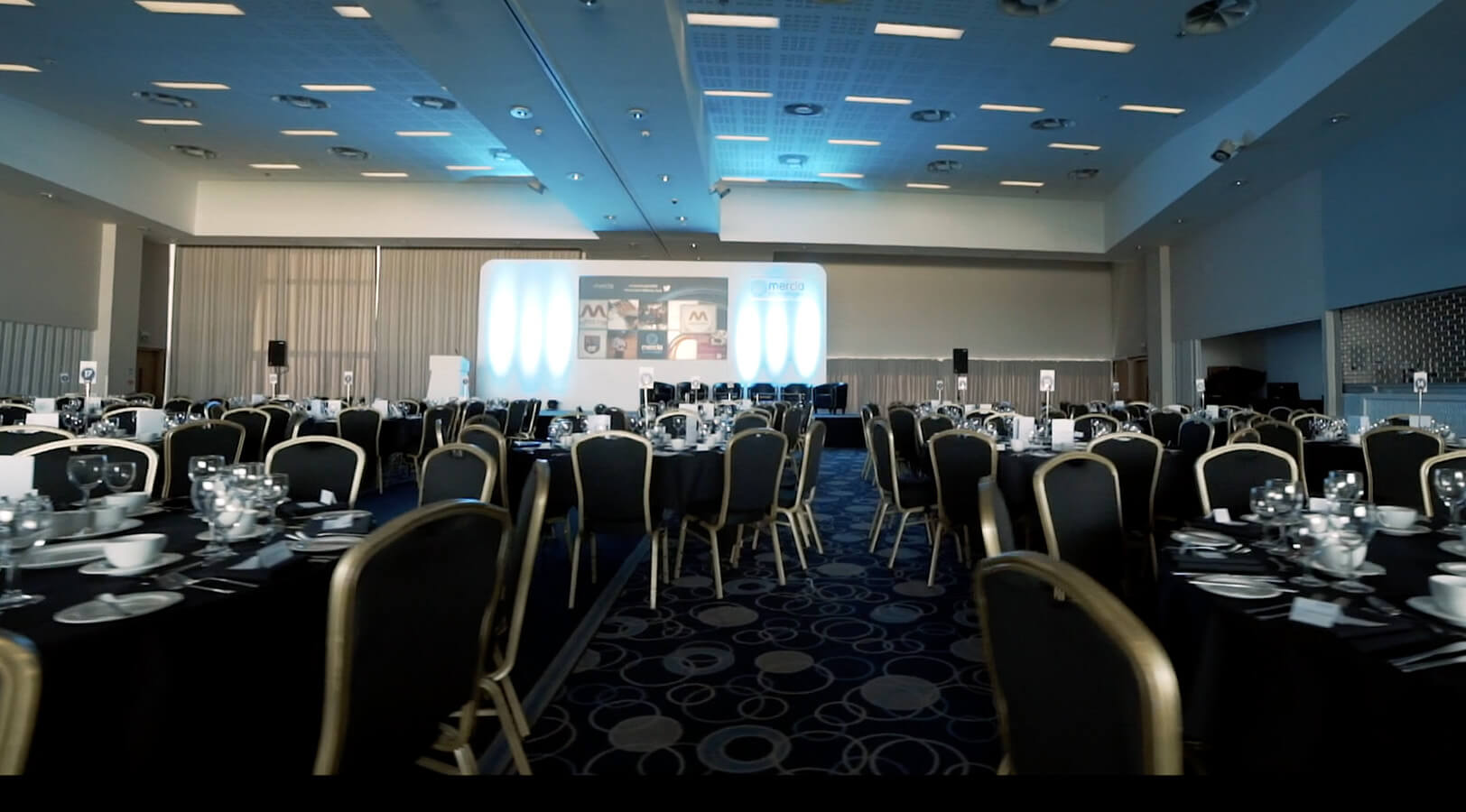 Banqueting suite at Edgbaston Stadium with LED lighting, perfect for gala dinners and events.