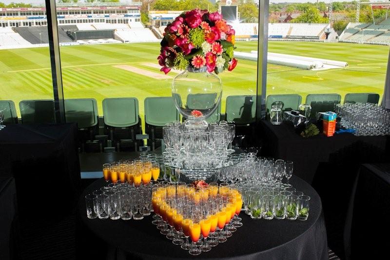 Elegant beverage station with floral display at Edgbaston Stadium for networking events.