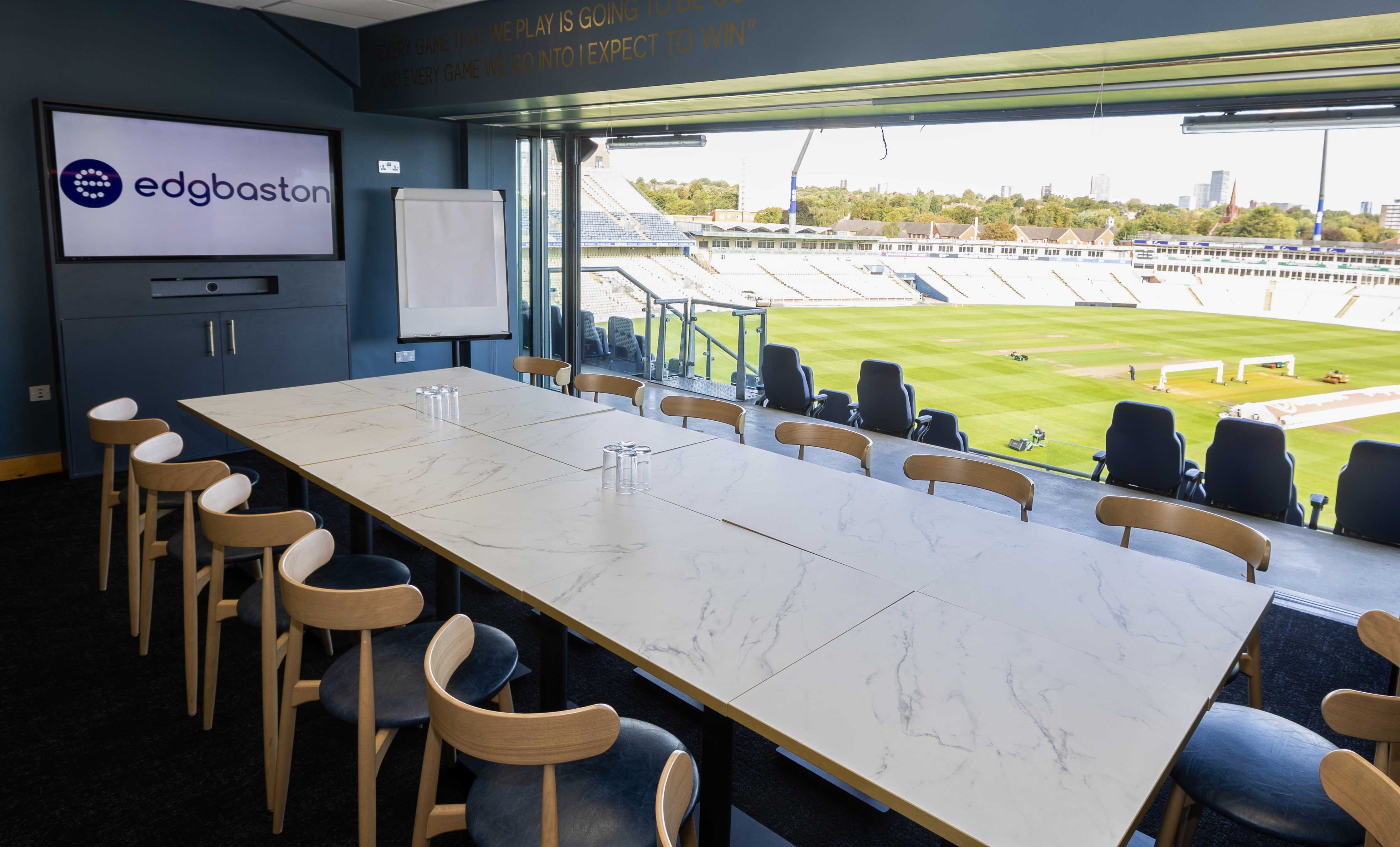 VIP boardroom with pitch view at Edgbaston Stadium for corporate hospitality and strategy events.