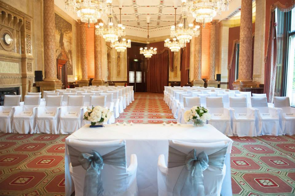 Elegant event space with white chairs and blue sashes at The Royal Horseguards Hotel.