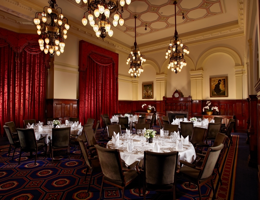 Elegant banquet hall with wood paneling, ideal for corporate dinners and formal events.