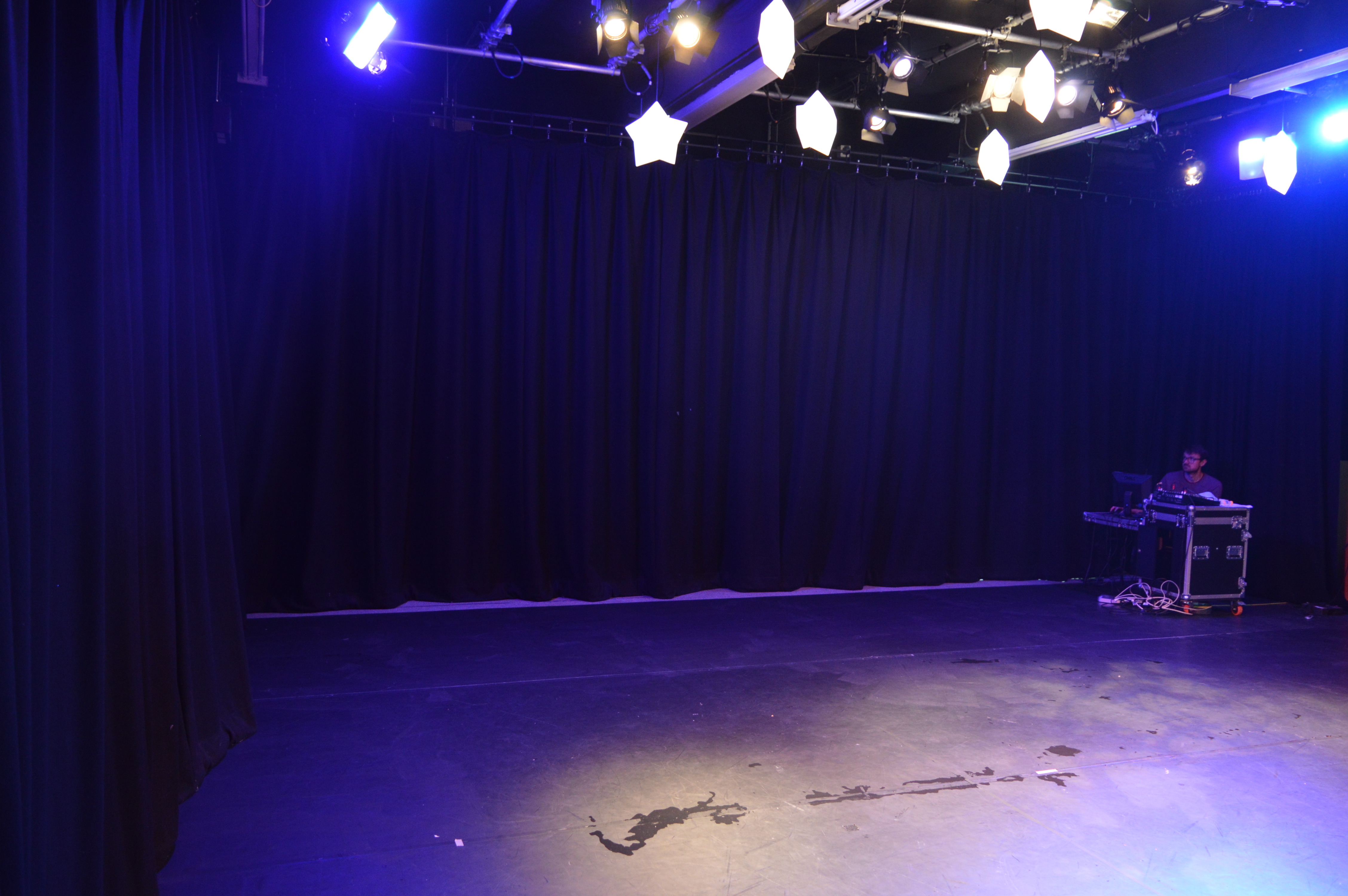 Versatile event space at Little Angel Studios with dark backdrop for presentations and performances.