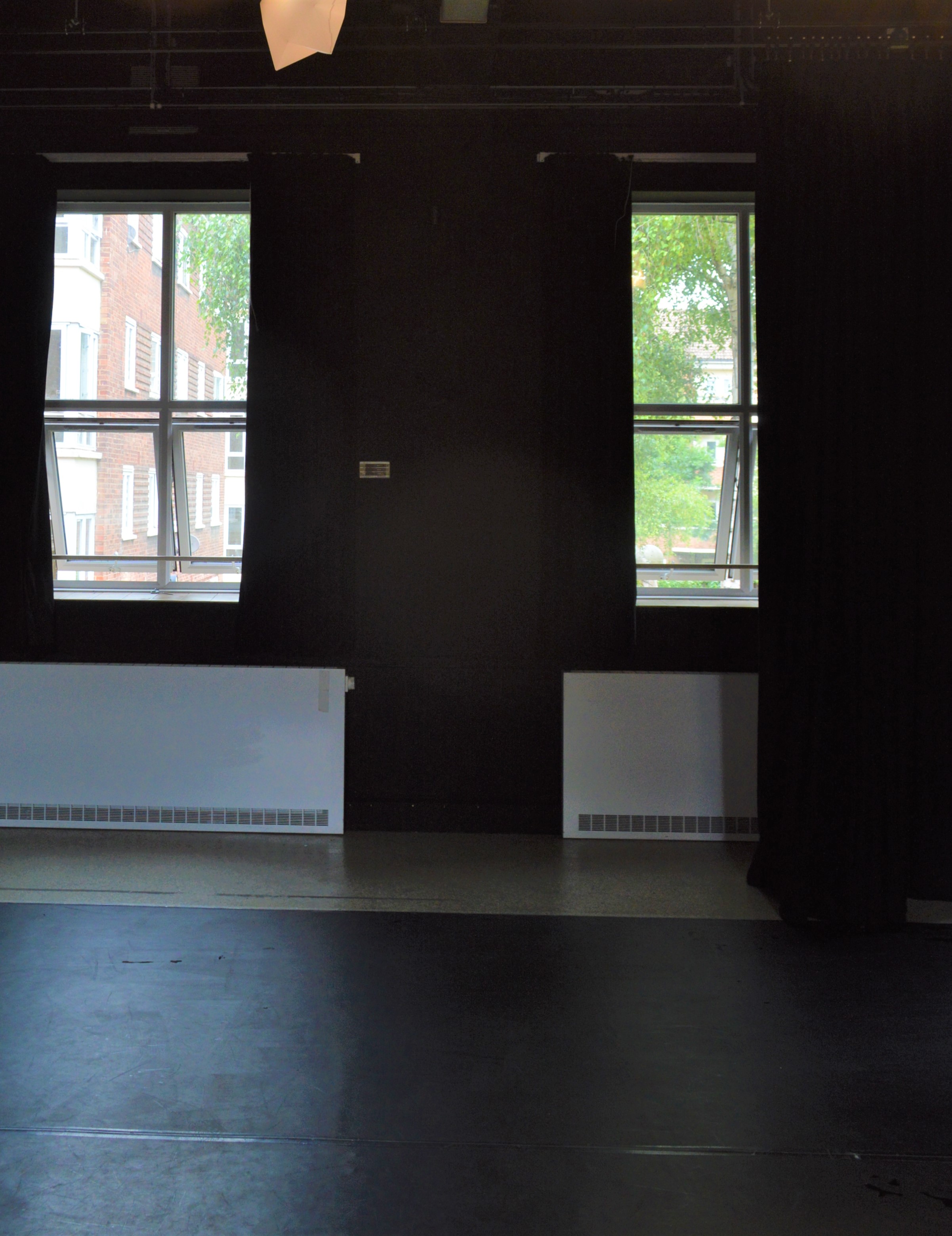 Cozy event space with large windows for intimate meetings and workshops at Little Angel Studios.