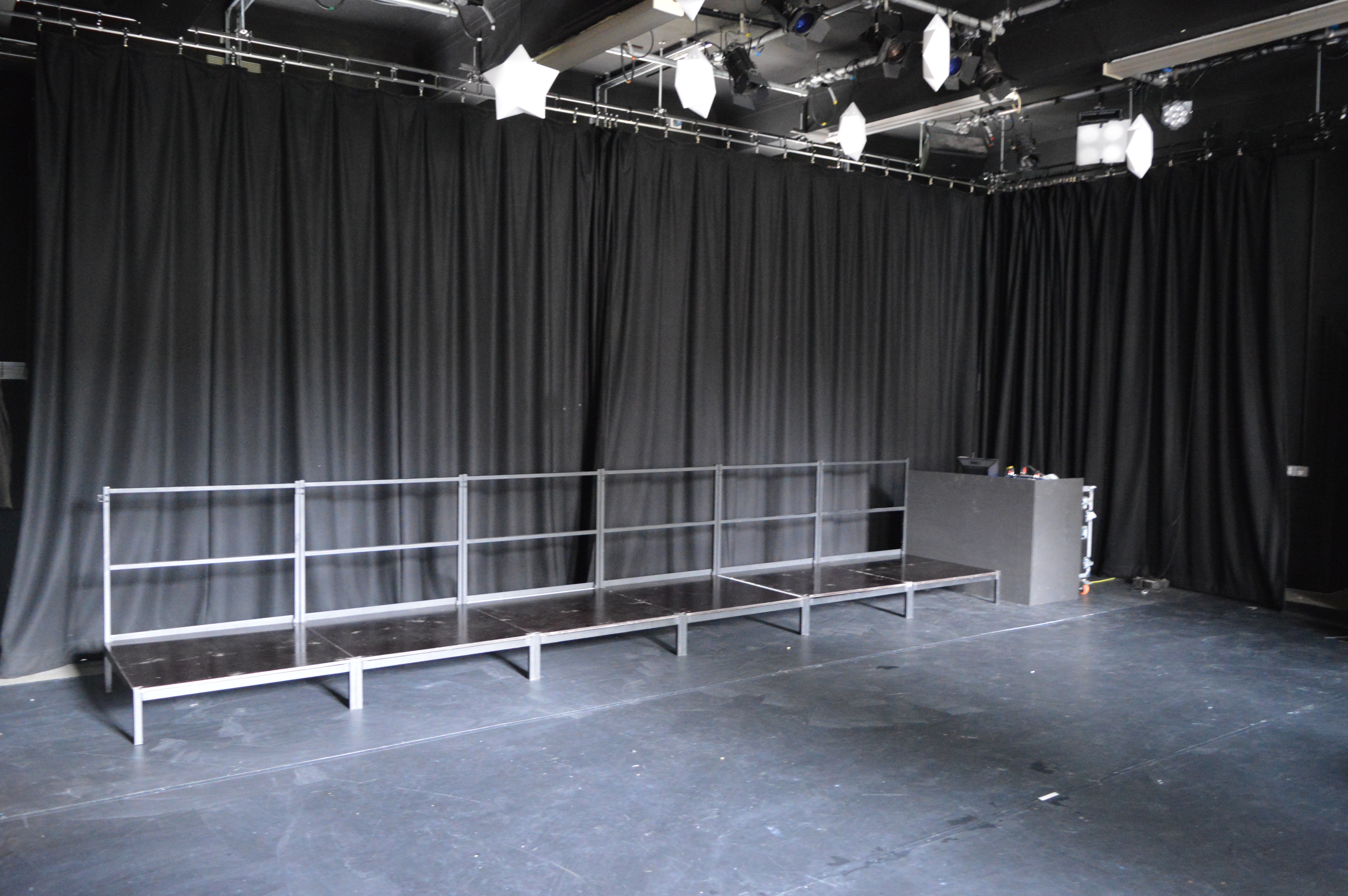 Versatile event space with minimalist stage at Little Angel Studios for presentations and workshops.