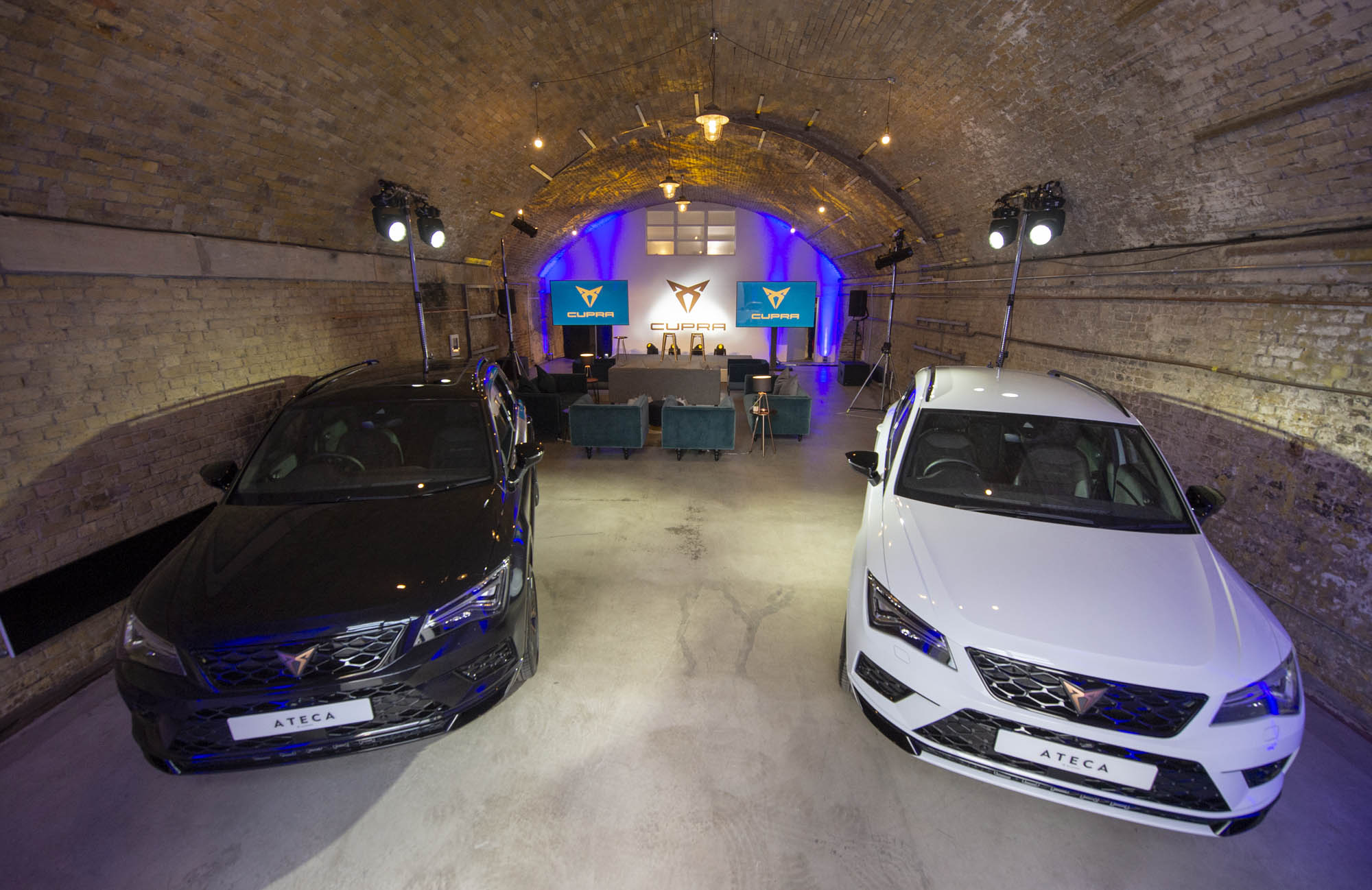Stylish event space with sleek cars, perfect for automotive product launches.