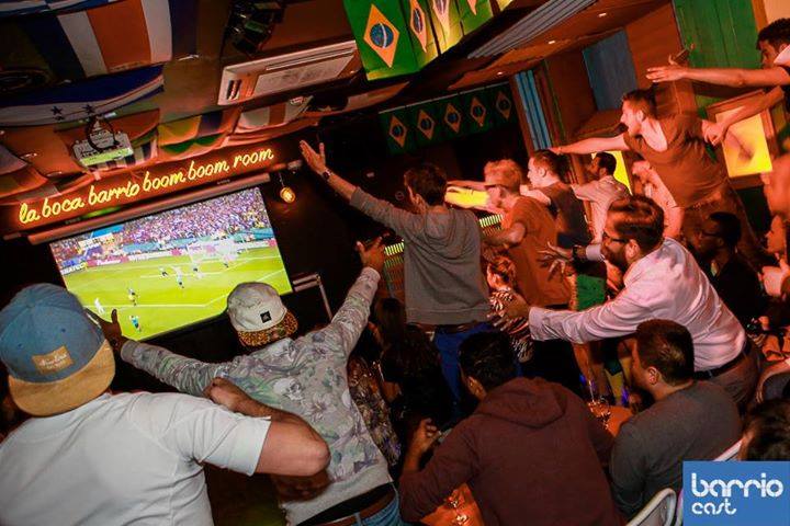 Lively venue in Shoreditch with cheering crowd during major sporting event.