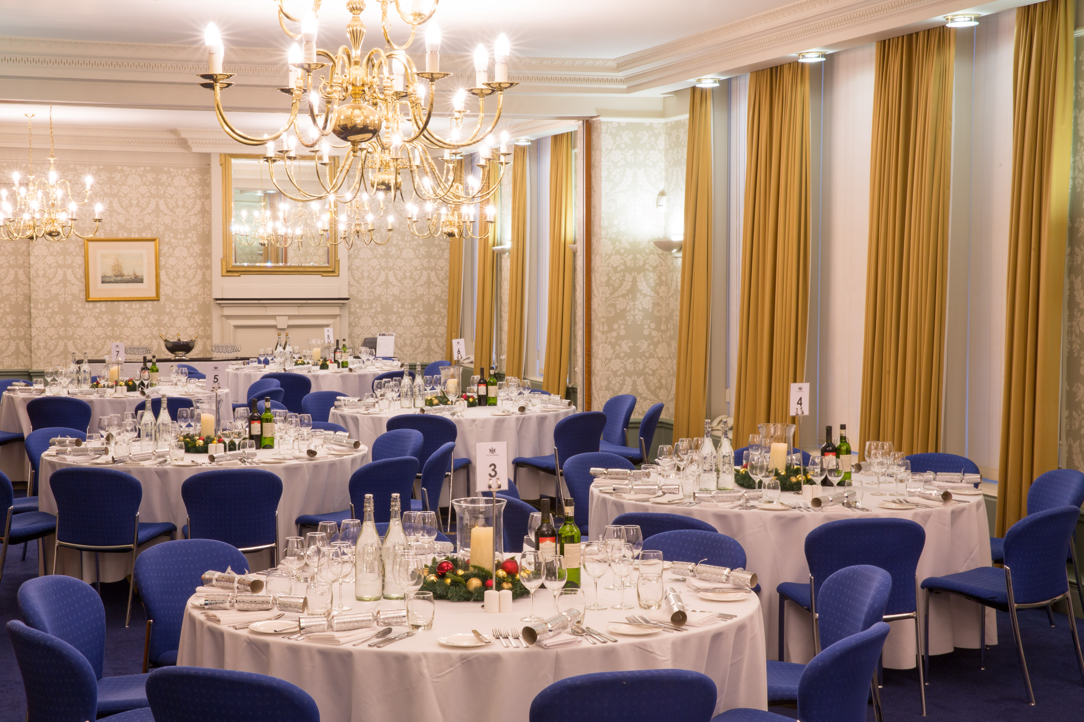 Elegant banquet room with round tables, ideal for corporate dinners and gala events.