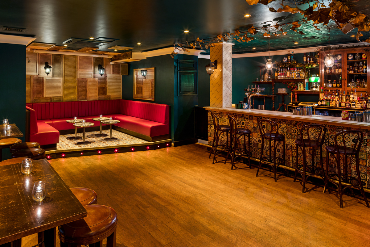 Stylish venue in Shoreditch with plush red booths for intimate cocktail events.