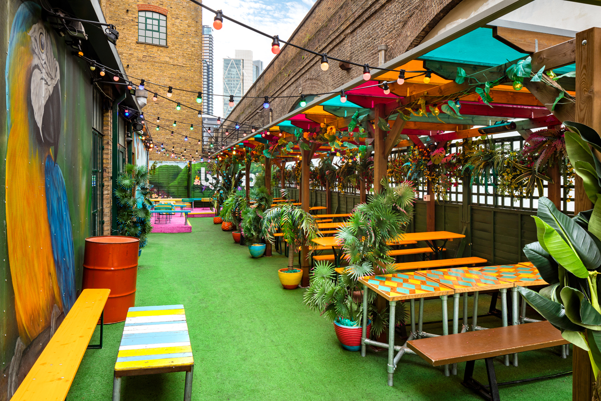 Vibrant outdoor event space in Shoreditch with colorful decor and string lights.