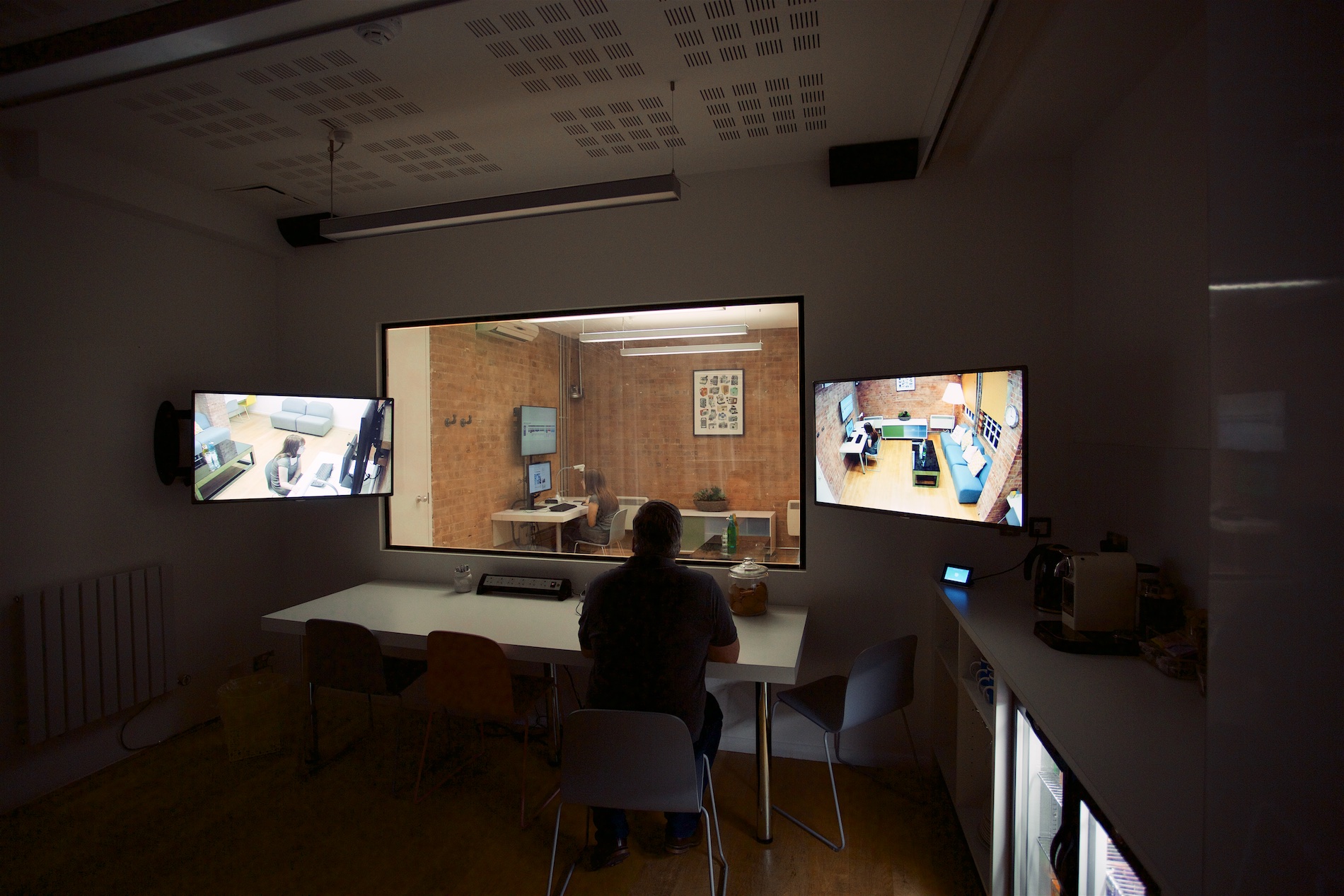Modern meeting room in Sutherland Labs with screens for hybrid events and collaboration.