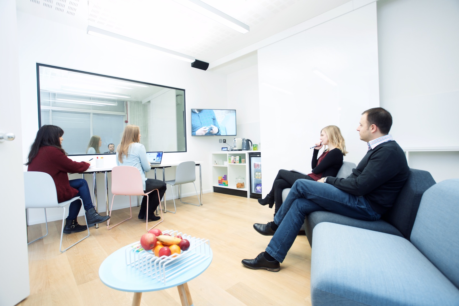 Modern meeting space with glass wall, ideal for collaborative brainstorming sessions.