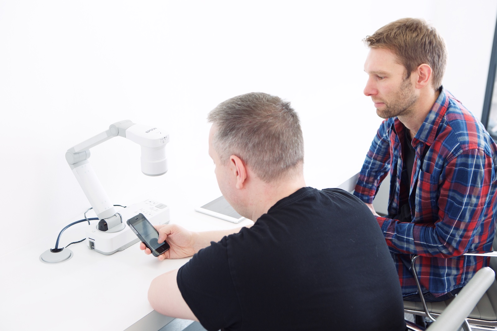 Professionals collaborating in The Basement, Sutherland Labs, ideal for tech presentations.