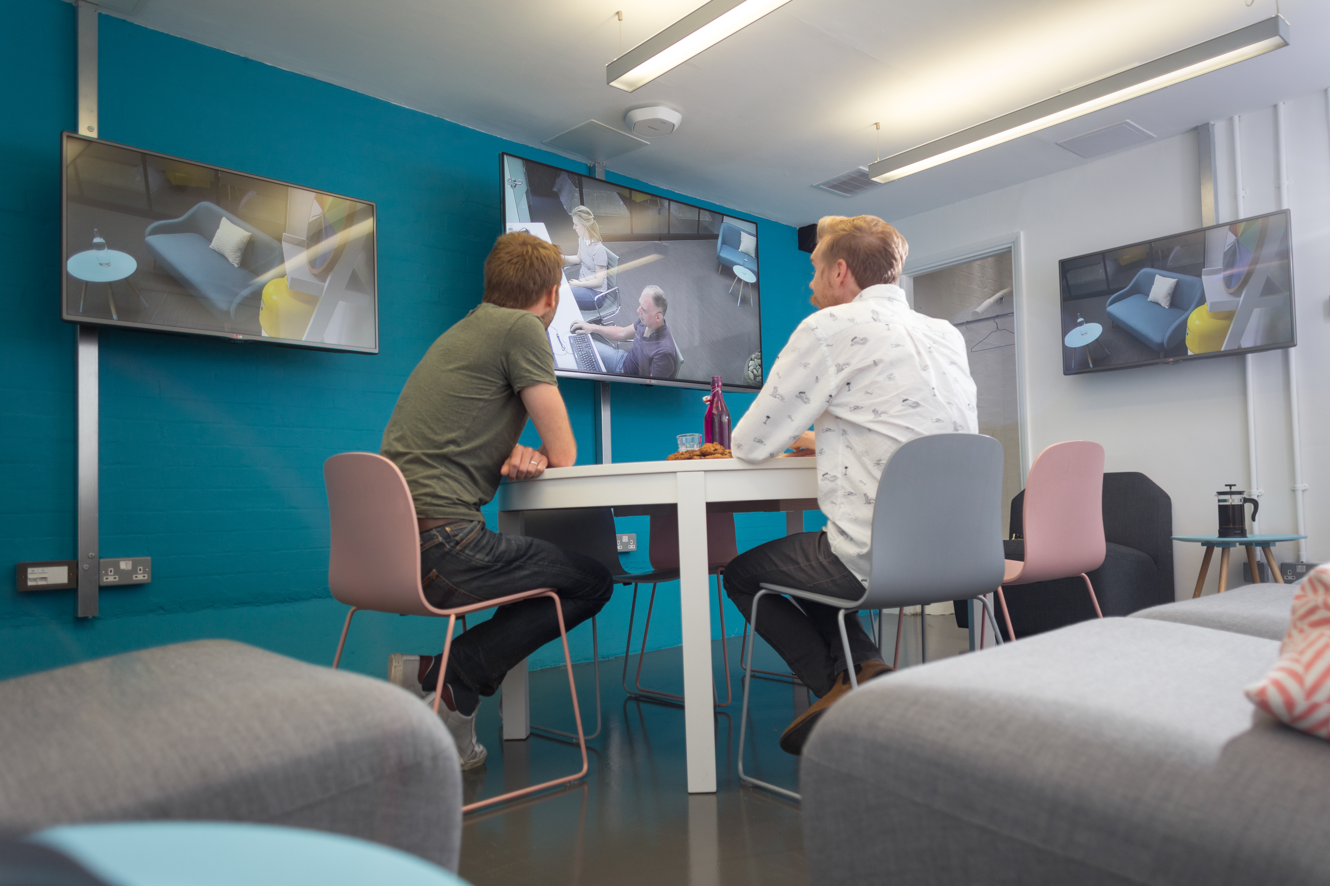 Modern meeting space in Sutherland Labs with screens for collaboration and brainstorming.