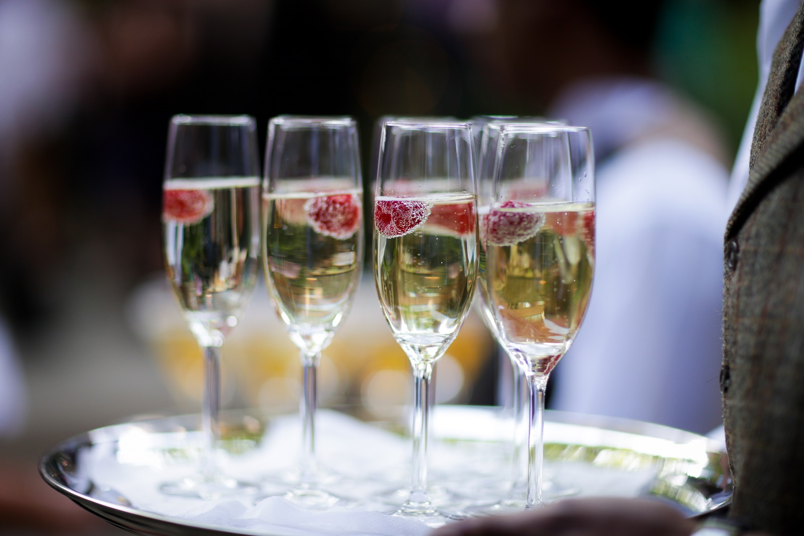 Champagne flutes with raspberries at The City Garden, perfect for events and celebrations.
