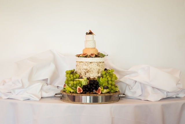Elegant three-tier cake with fresh fruits for weddings and upscale events.