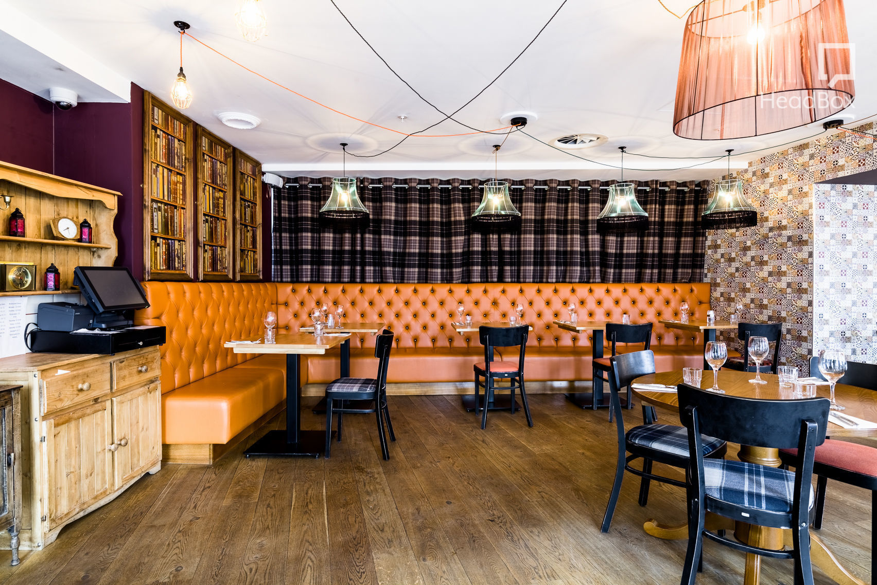 Cozy dining space with orange leather banquettes for business dinners and networking events.
