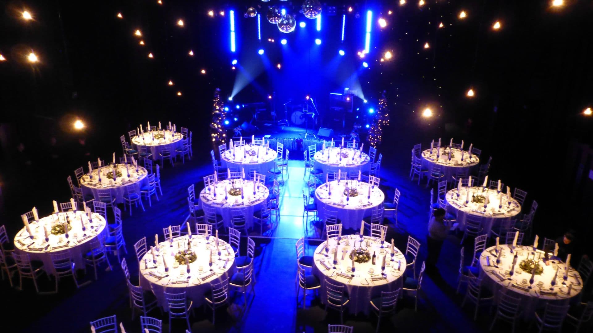 The Studio Theatre gala setup with stage and round tables for corporate event venue hire.