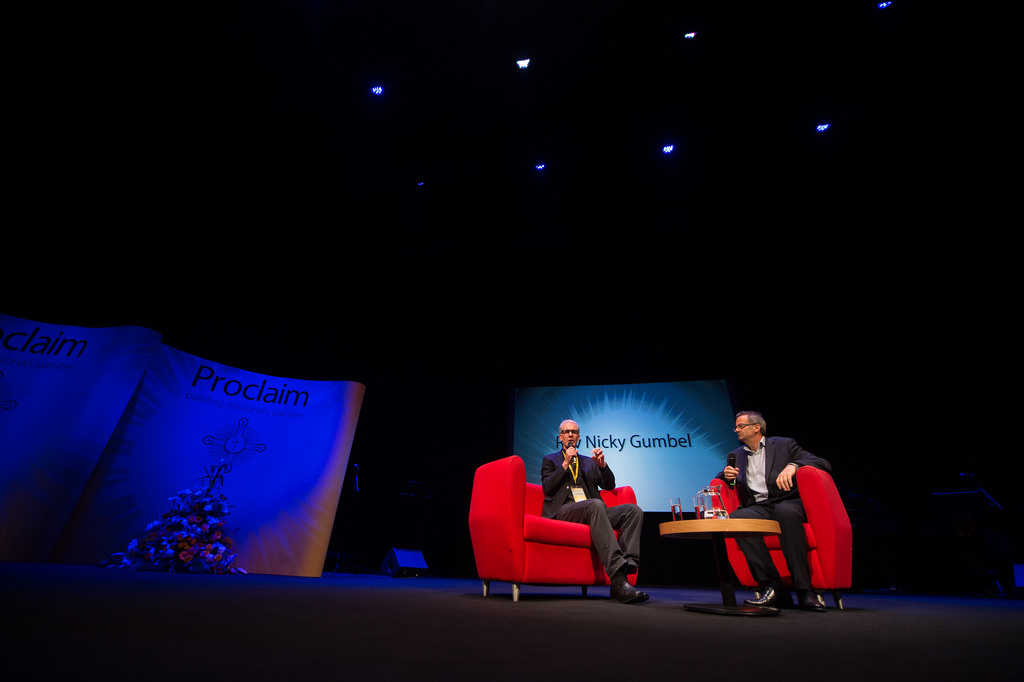 Panel discussion stage setup with red chairs at The House, Birmingham REP venue.