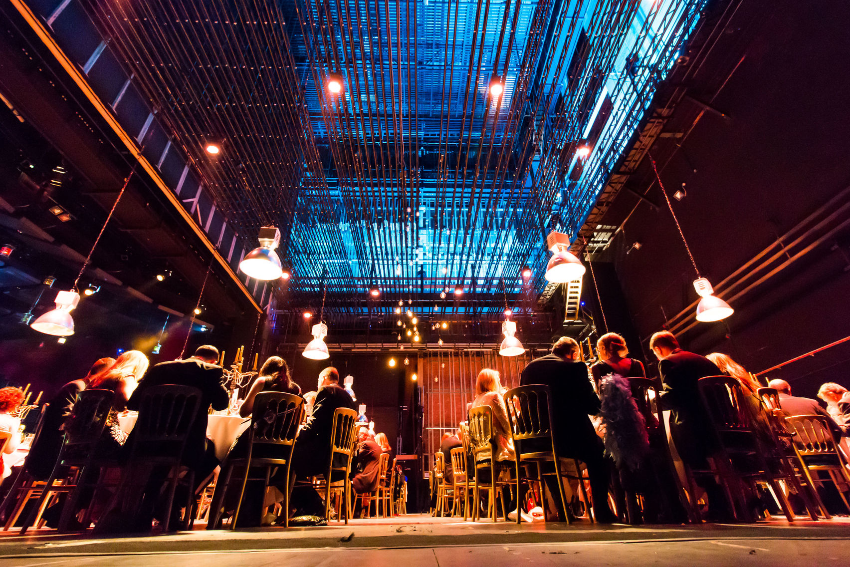 Elegant long table setup under industrial lighting at The House in Birmingham for events.