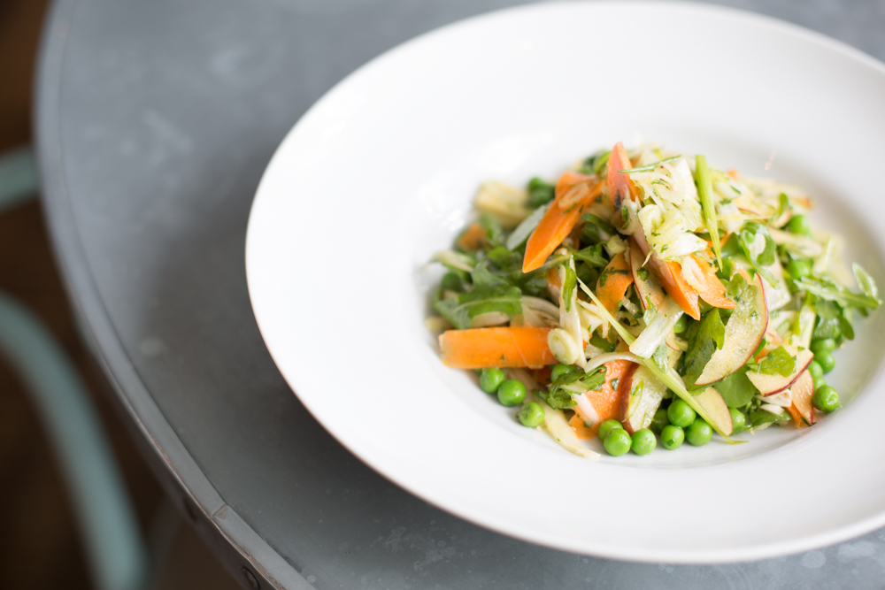 Vibrant salad on white plate for healthy catering at networking lunches and events.