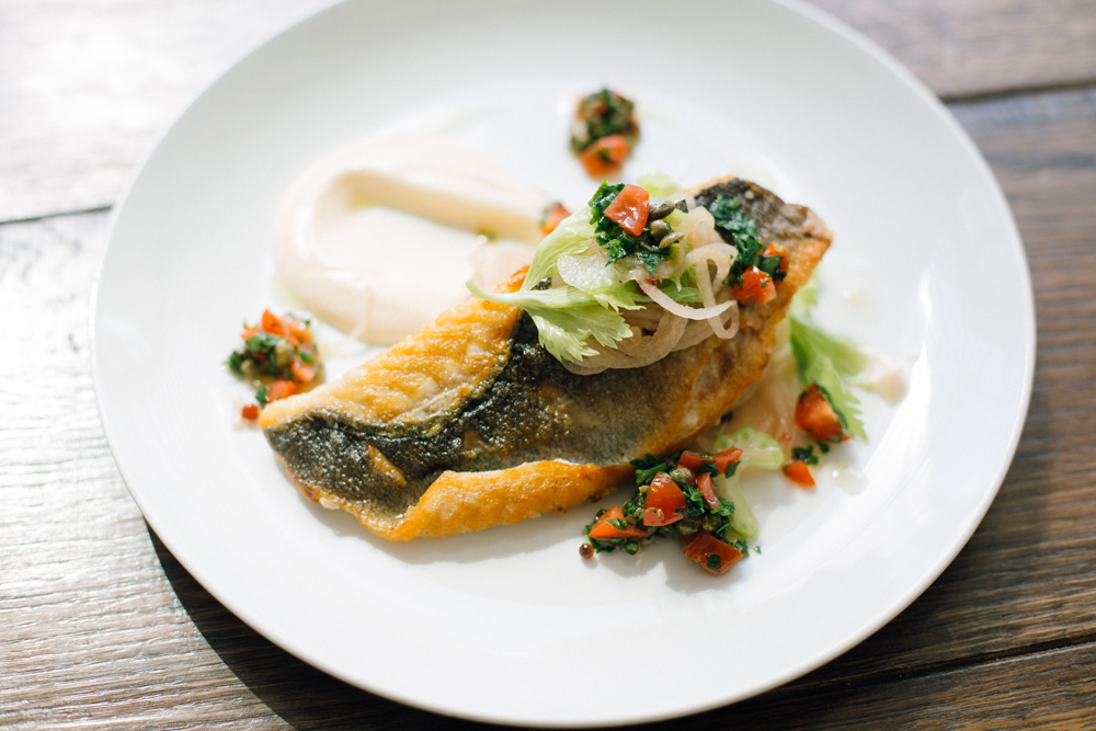 Elegantly plated fish dish with fresh salsa at The Pearson Room event venue.