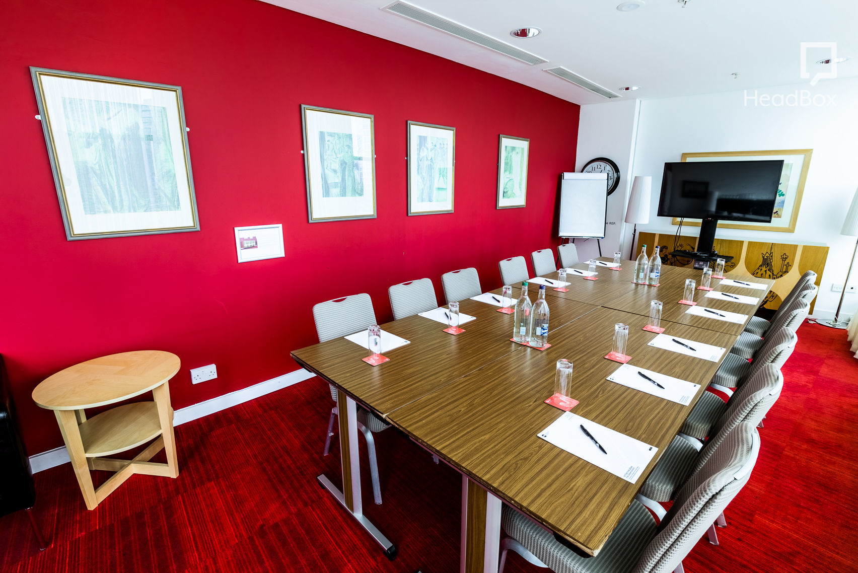 Meeting room with red walls at Unique Venues Birmingham for professional events.