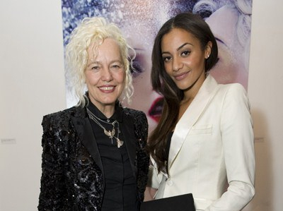 Elegant women at Gallery Different, vibrant backdrop, fashion gala event.