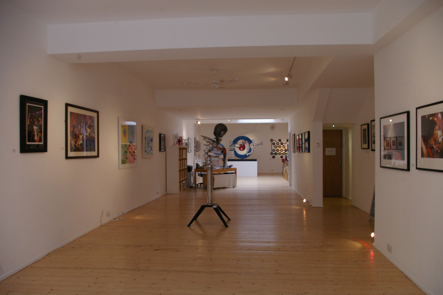 Spacious art gallery with wooden floors, perfect for exhibitions and networking events.