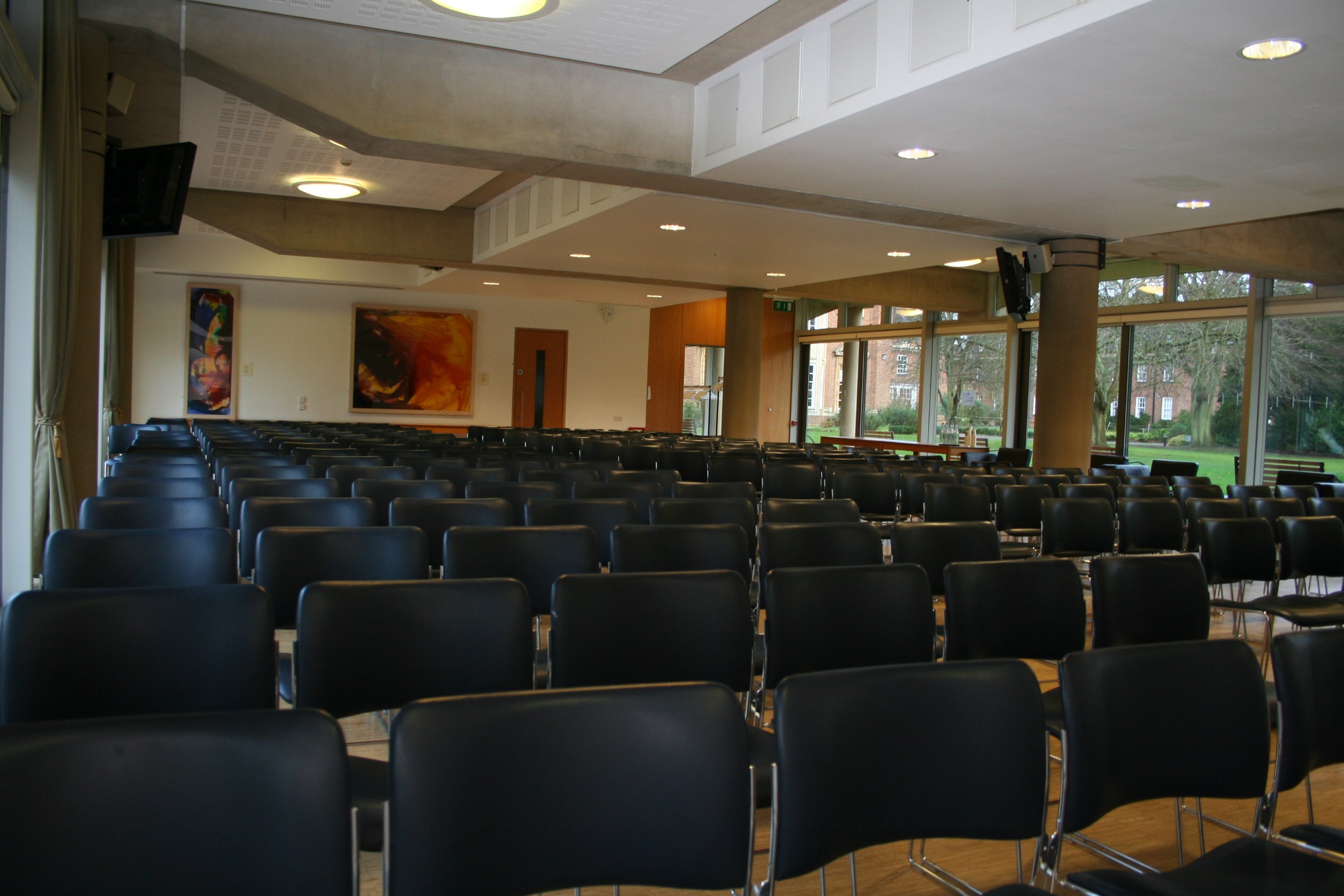 Maplethorpe Hall meeting room with black chairs, perfect for conferences and seminars.