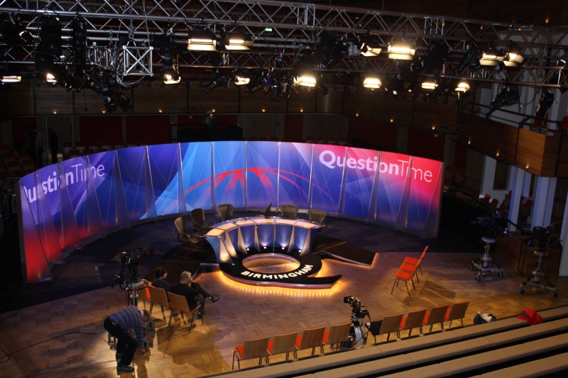 Elgar Concert Hall studio set for live debate, featuring circular seating and professional lighting.