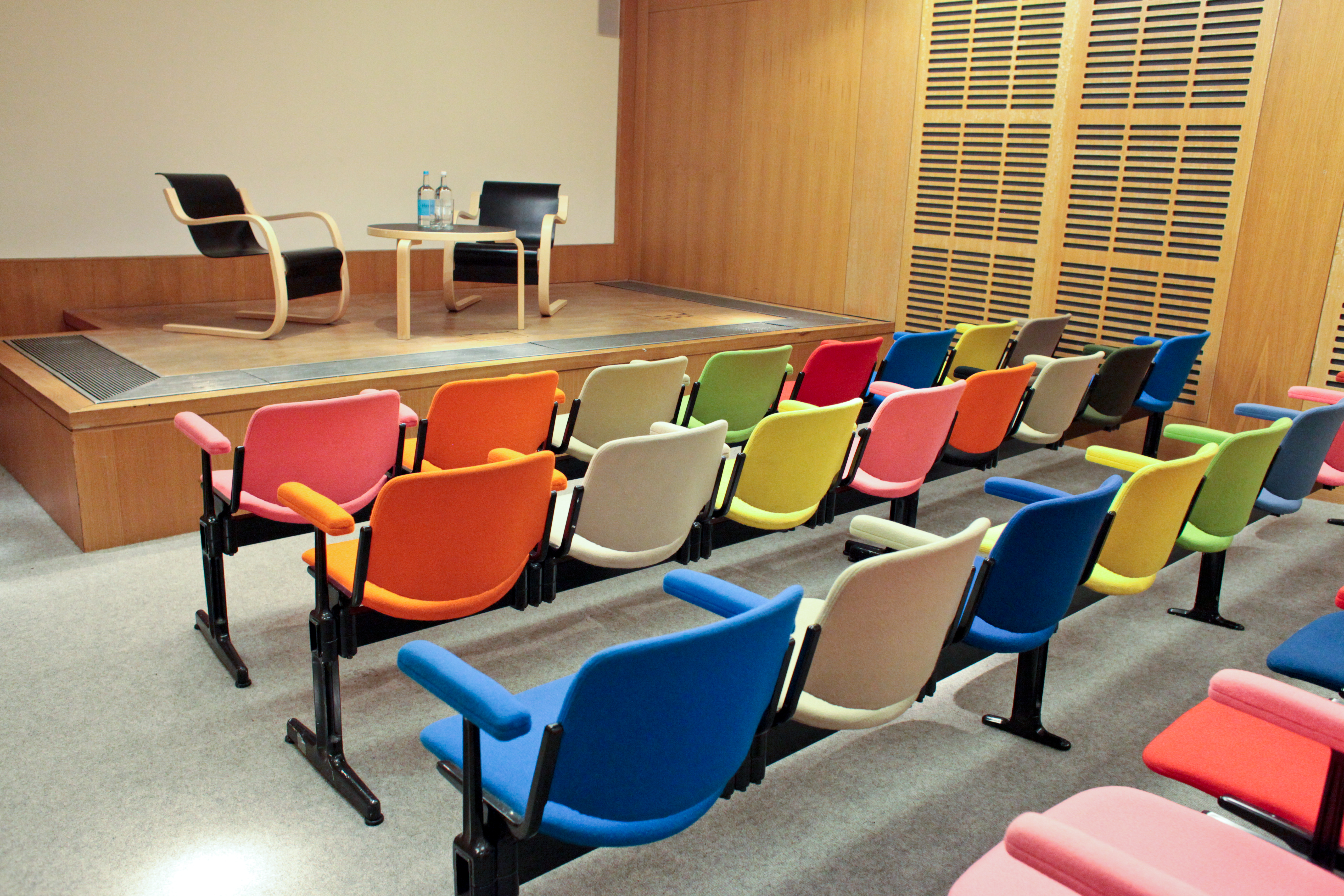 Zilkha Auditorium event space with minimalist stage, ideal for panel discussions and interviews.