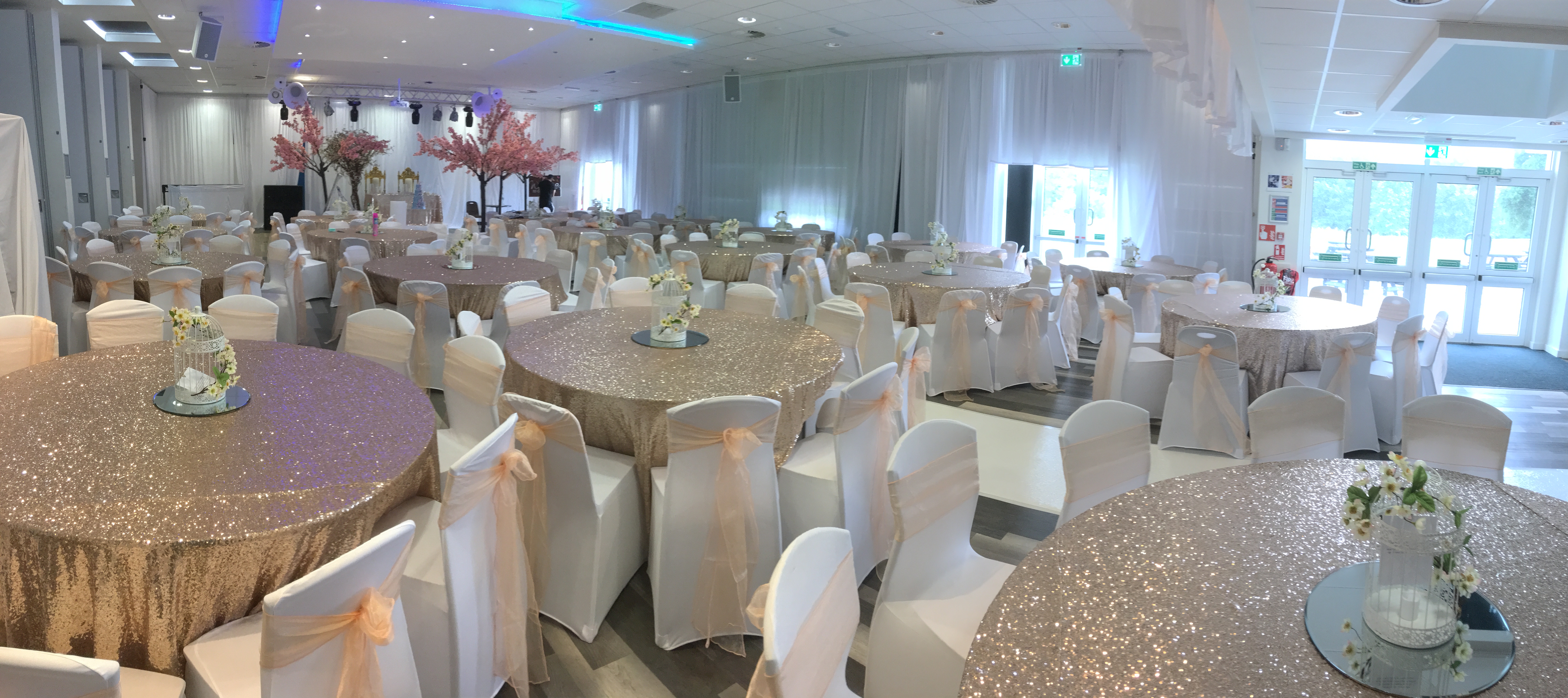 Elegant event space at Reading University with gold tables, perfect for weddings and gatherings.