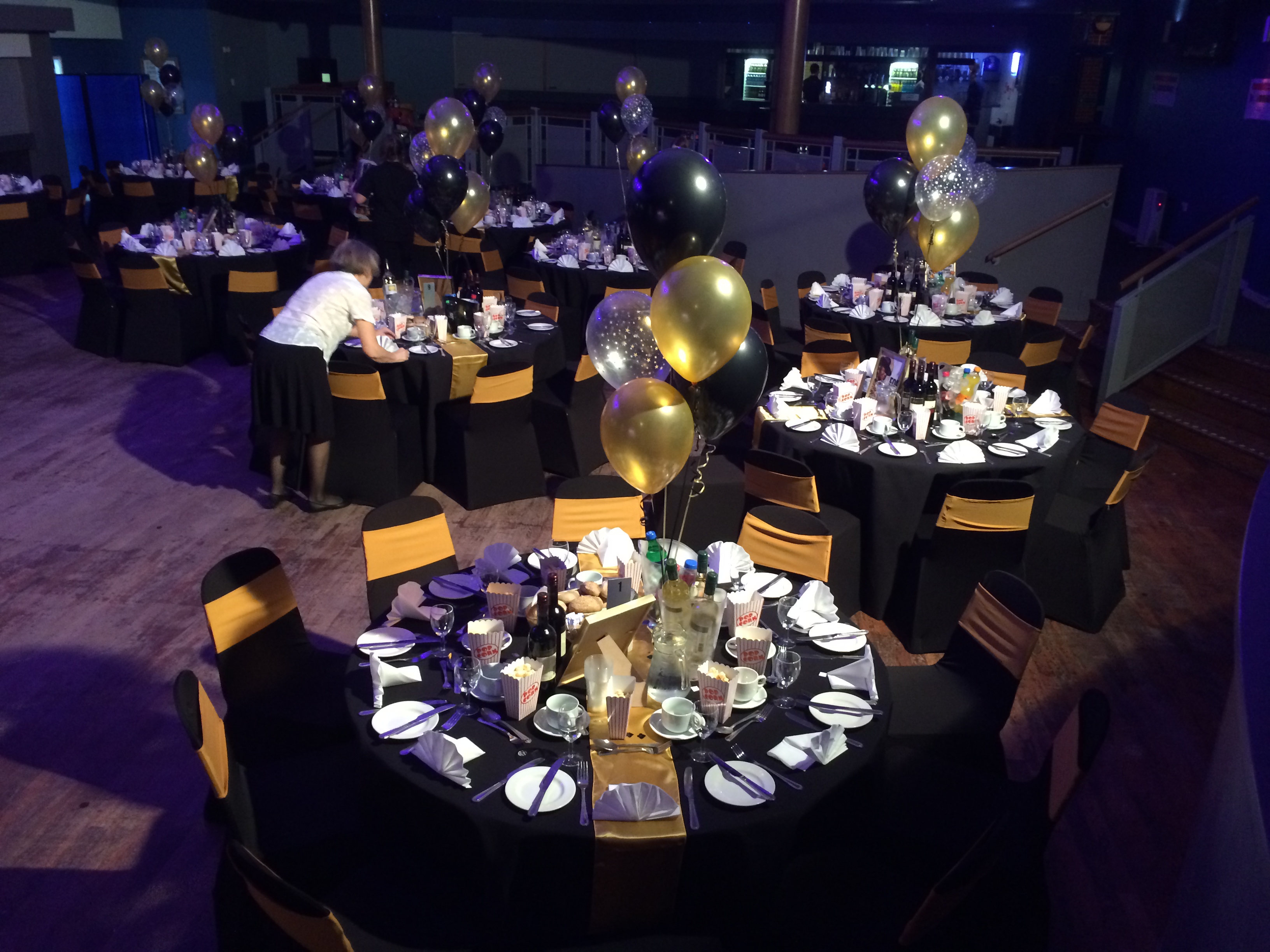 Formal event space at Reading University with elegant black and gold decor.