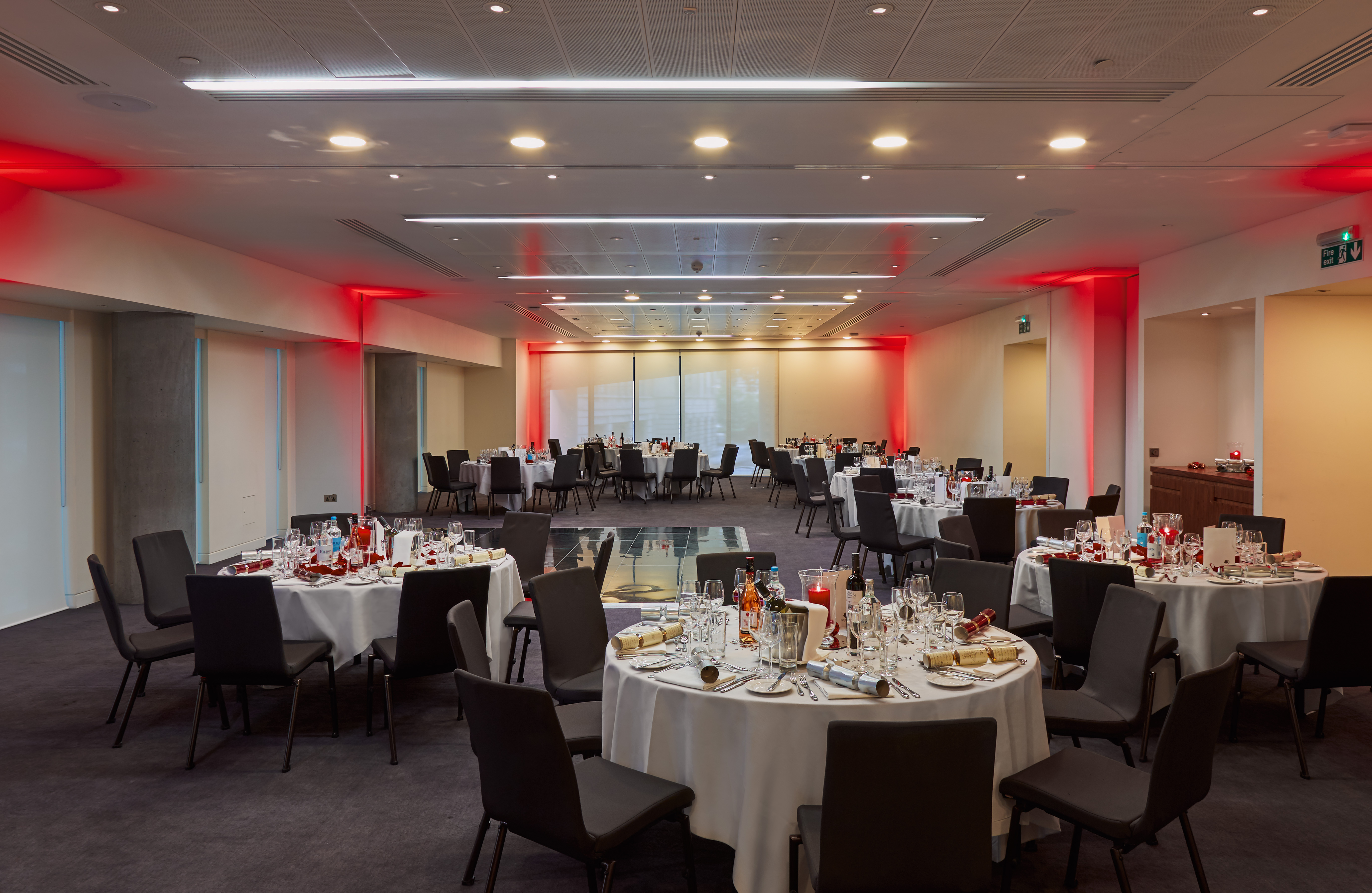 Elegant event space at DoubleTree by Hilton London with red ambient lighting.