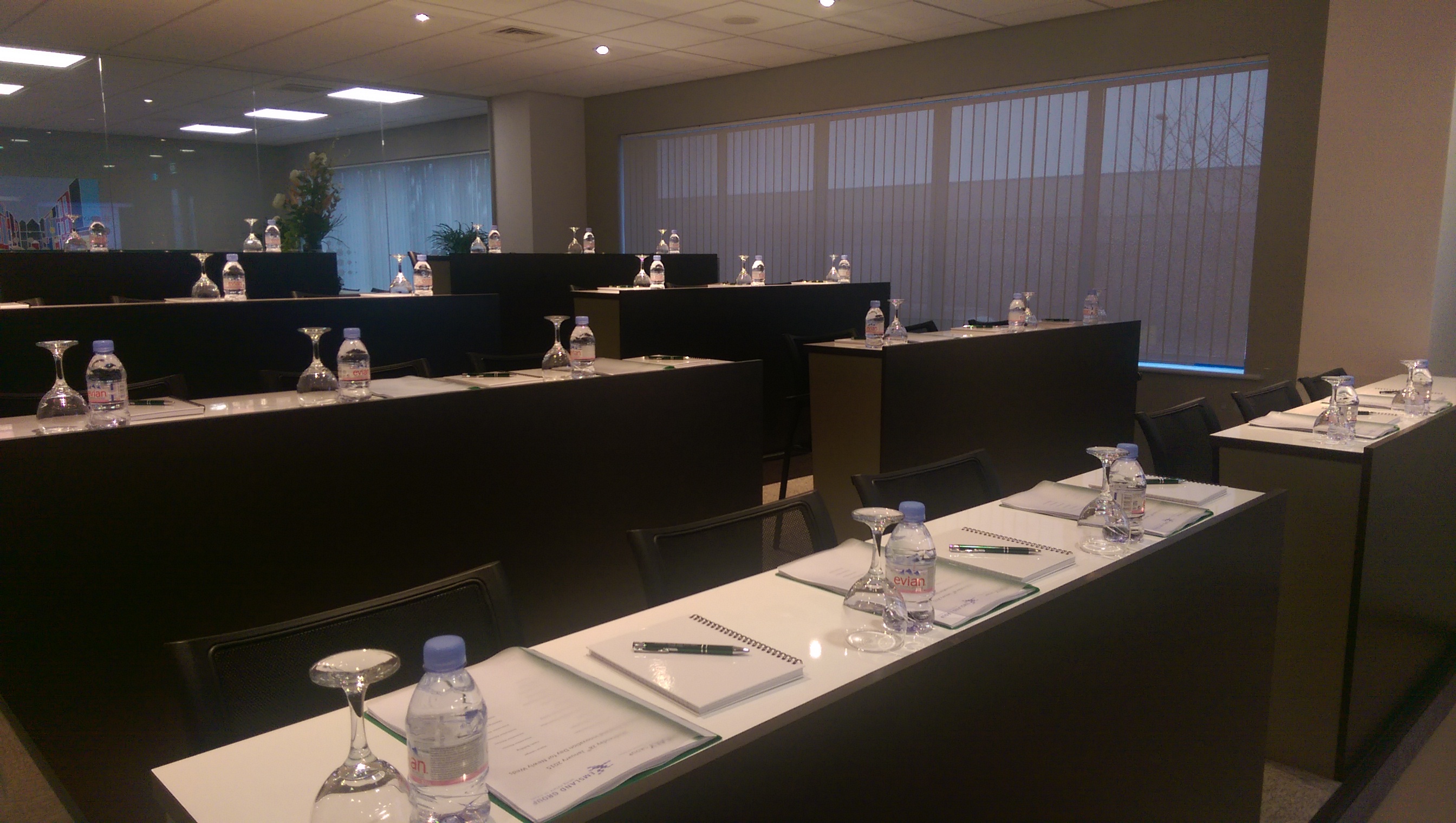 Professional meeting room with tiered seating, ready for events and discussions.