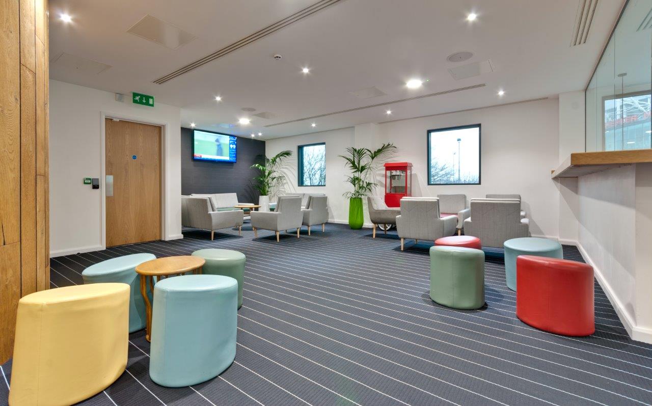 Modern Players Lounge at Hotel Football, vibrant seating for networking and meetings.