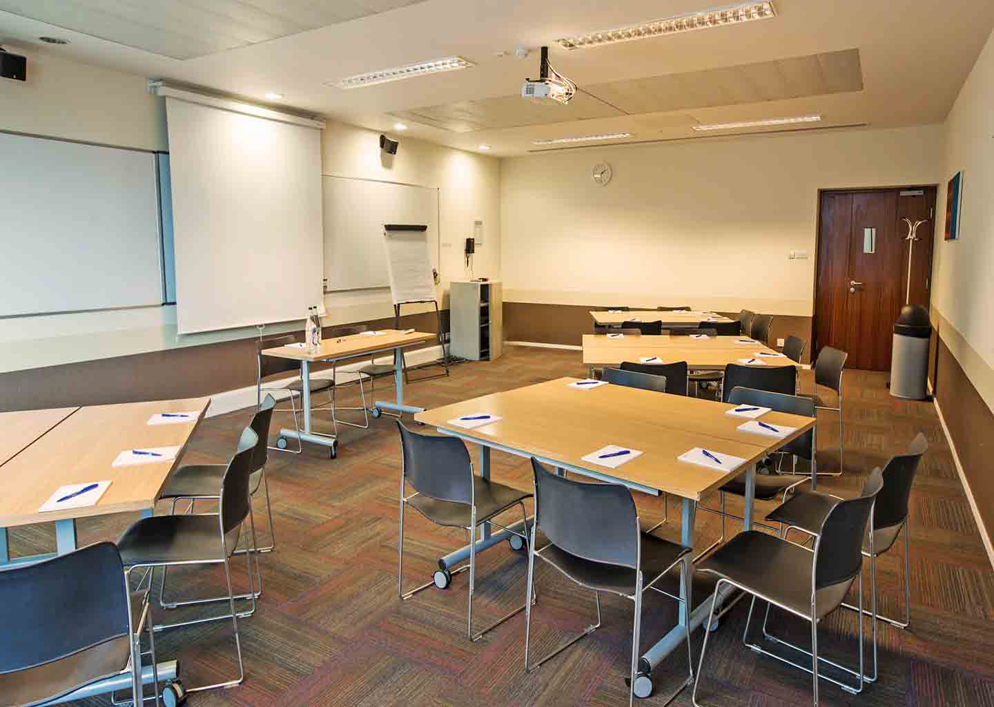 Meeting room at Imperial College, featuring tables for workshops and training sessions.