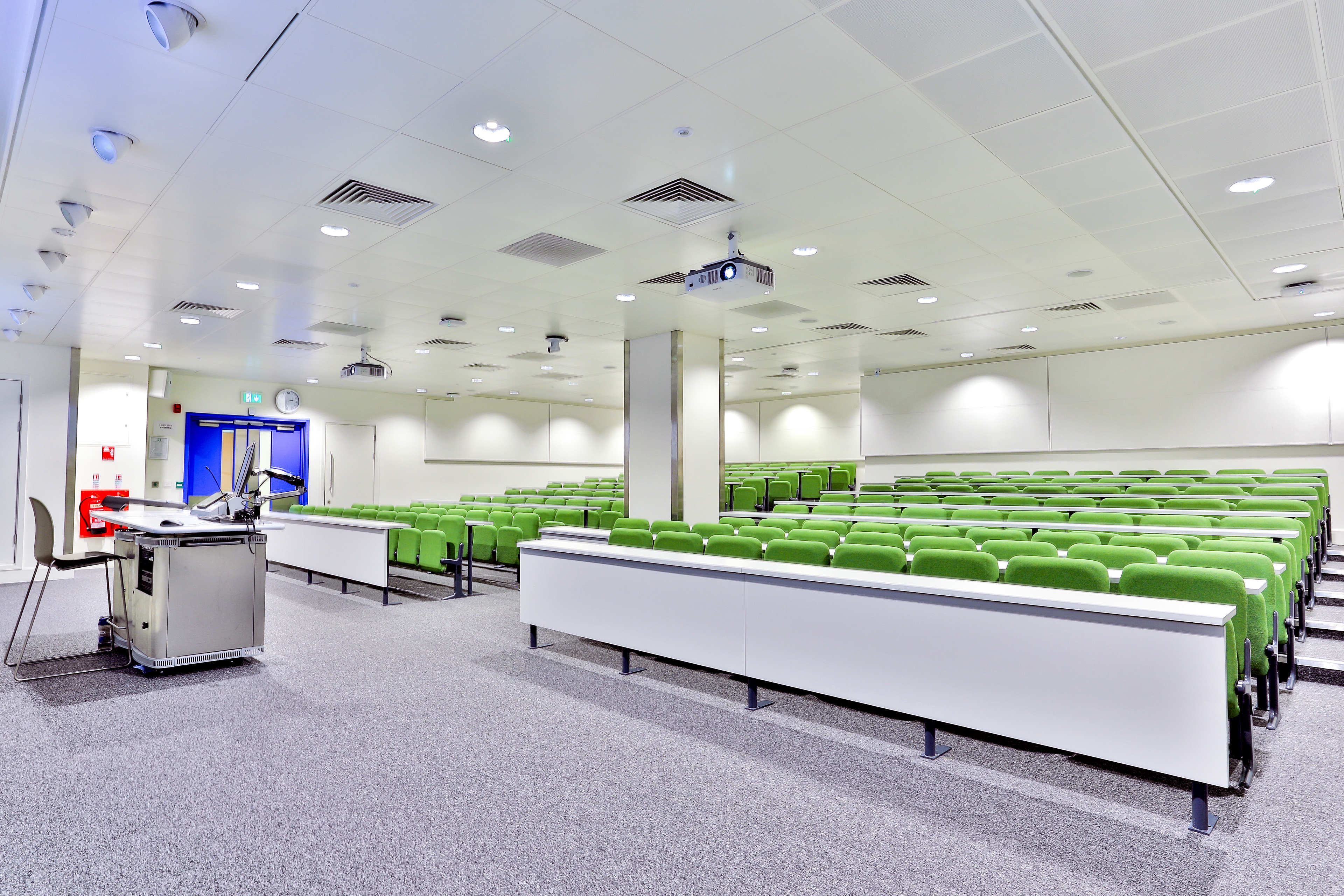 Modern conference room with tiered seating at Imperial College for lectures and presentations.