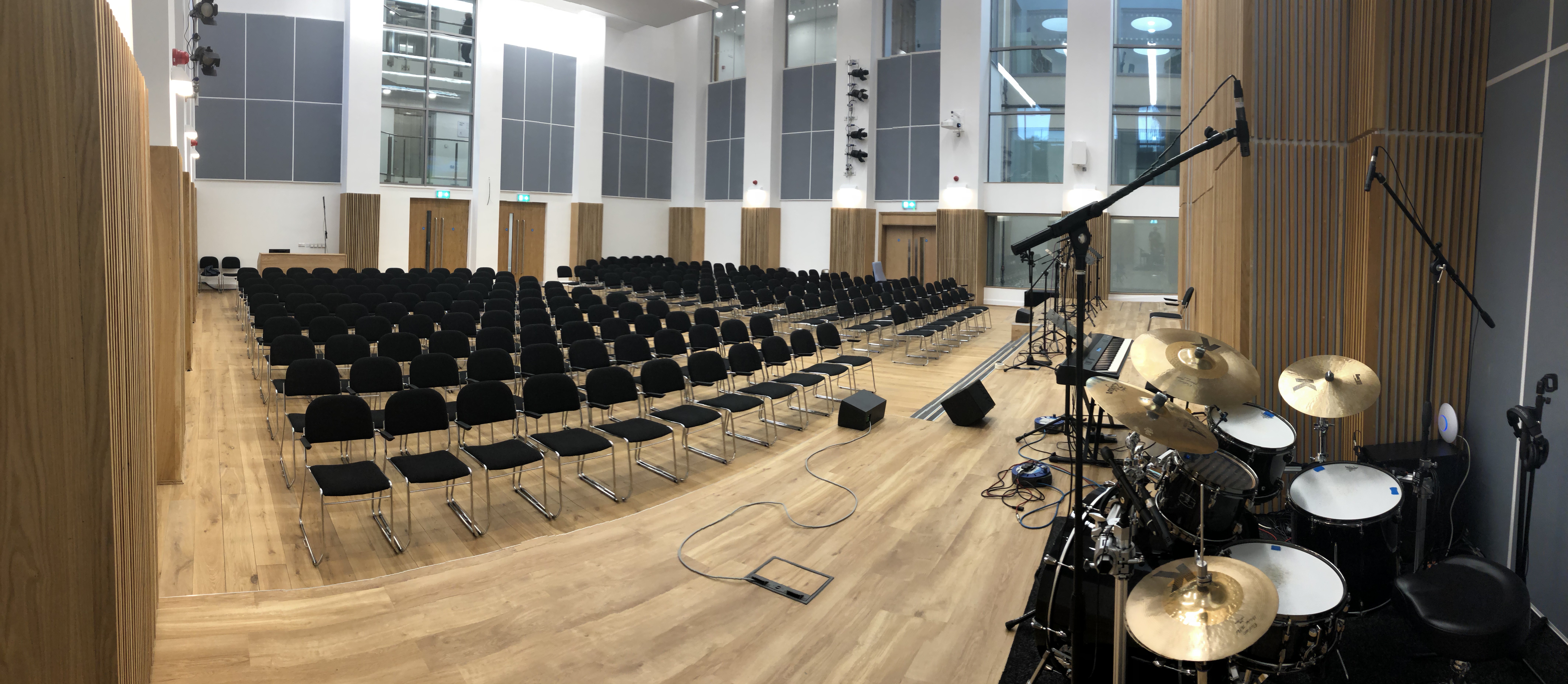 Westbourne Park Baptist Church auditorium with black chairs, ideal for conferences and performances.