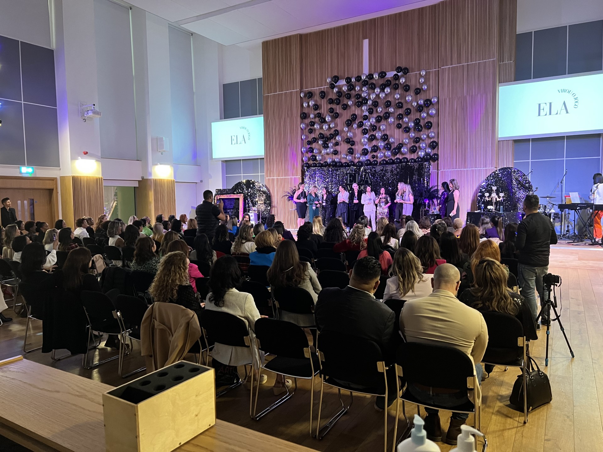 Westbourne Park Baptist Church auditorium during a lively presentation event with multimedia setup.