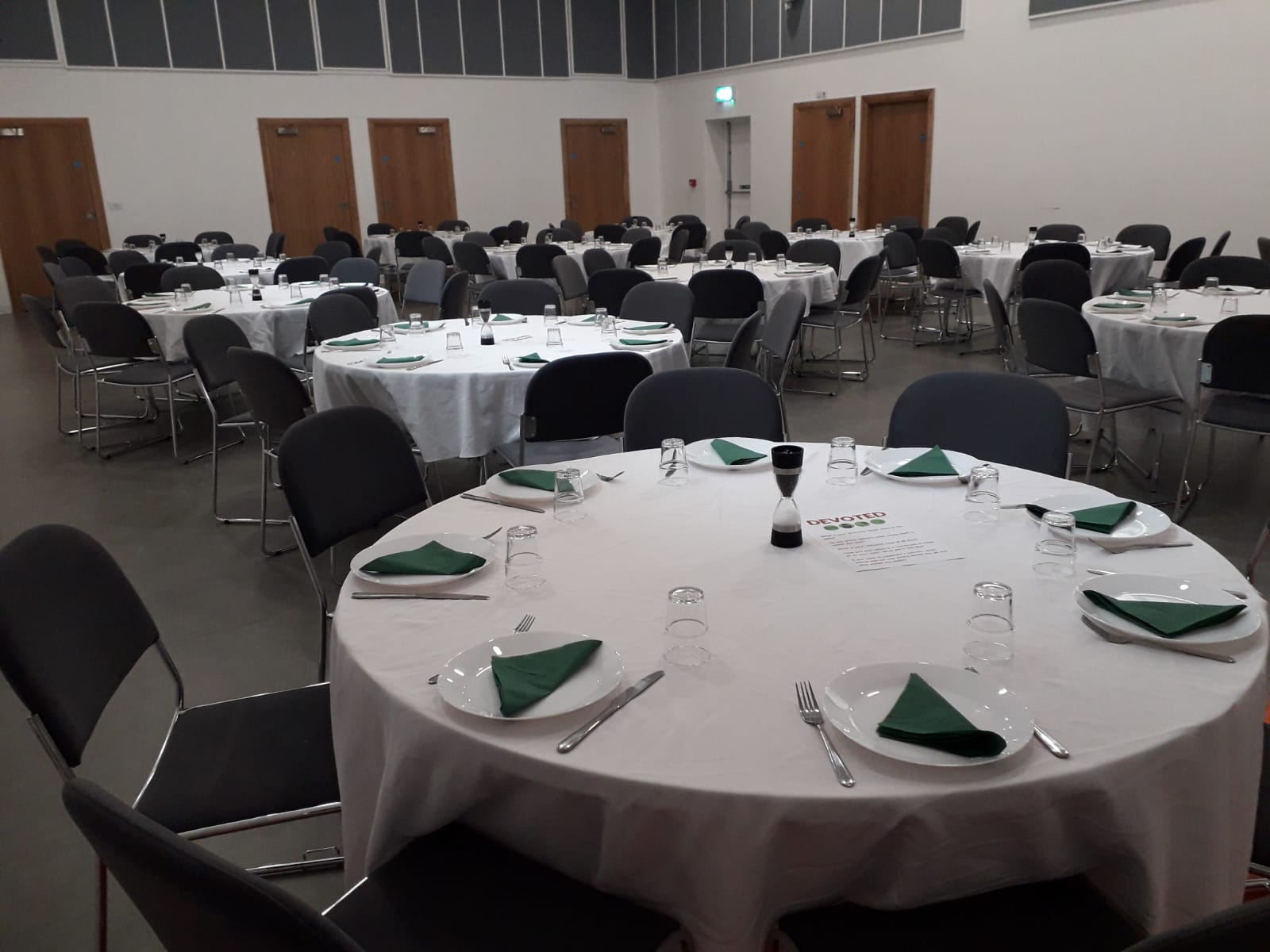 Elegant dining setup in Westbourne Park Baptist Church auditorium for corporate events.