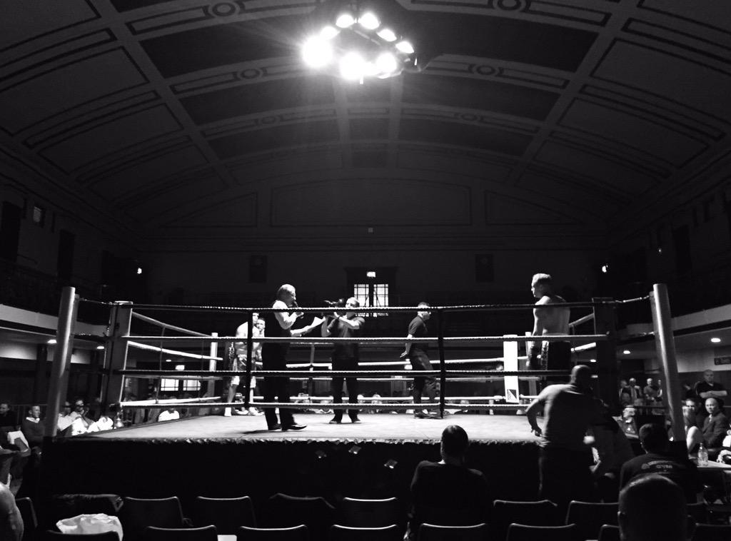 York Hall boxing ring, dynamic atmosphere for live sports event, audience engagement.