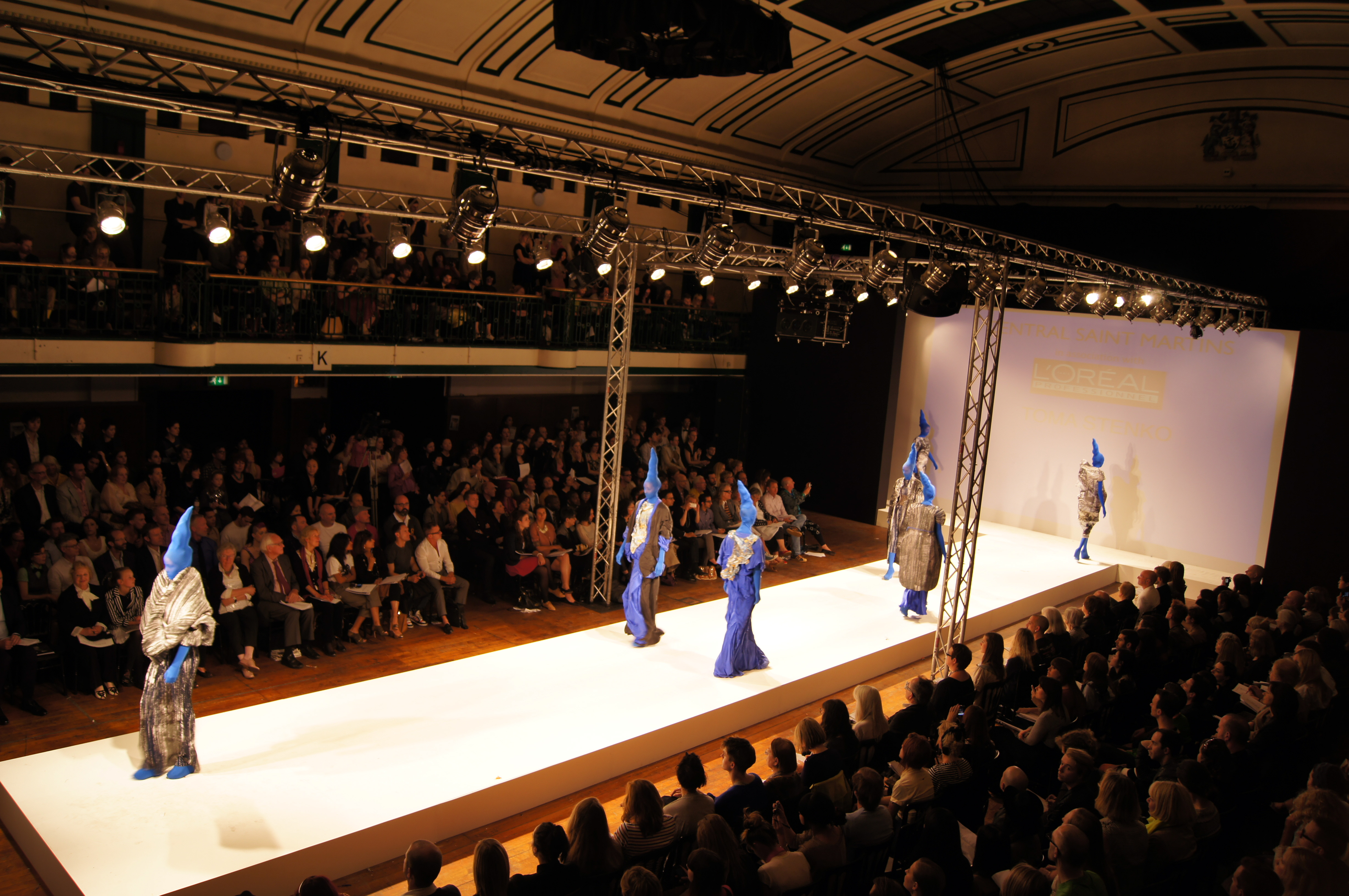 York Hall fashion runway event with models in striking blue outfits and vibrant atmosphere.