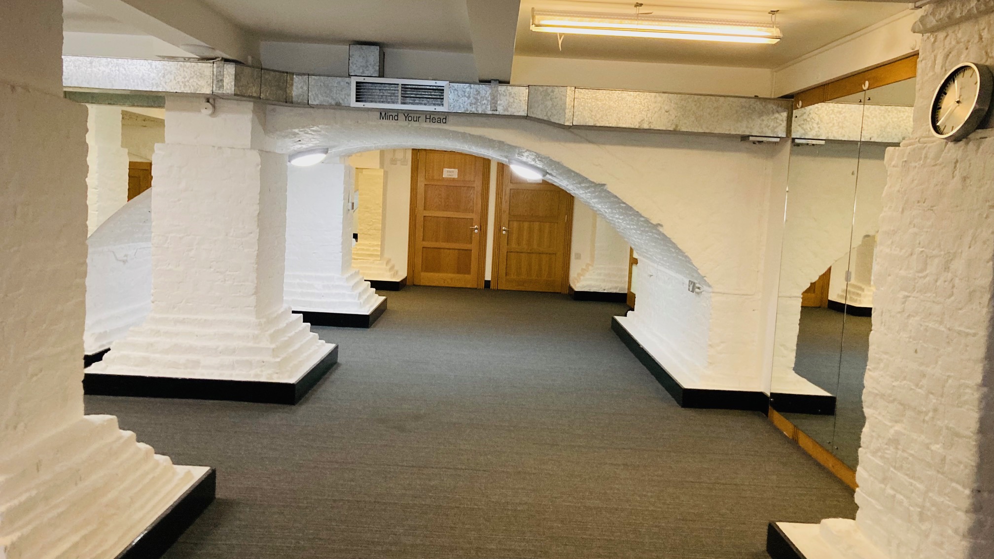 Versatile event space in St John's Hoxton with arched pillars for corporate meetings and workshops.