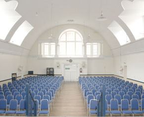 Mary Ward Hall event venue with blue chairs, ideal for conferences and seminars.